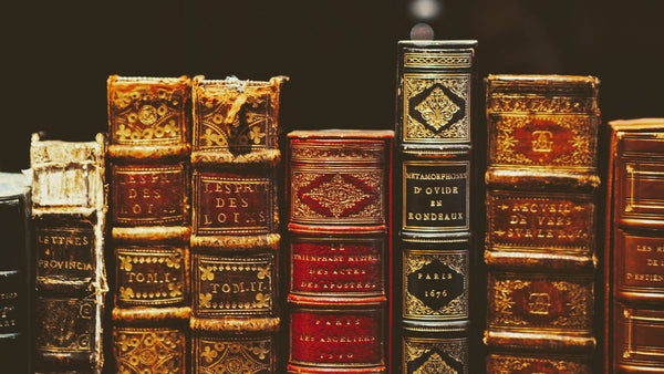 Old books stacked next to eachother