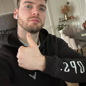 Customer wearing Black Juno Hoodie with thumbs up